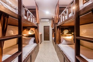 A narrow hallway with bunk beds on either side, a door at the end, and an air conditioning unit on the wall. - Awesome Dormitory (Mumbai)