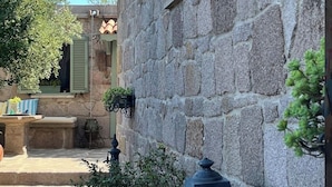 A stone building with shutters, a stone staircase, and a lantern. - Idasos Tasodalar (Ayvacik)