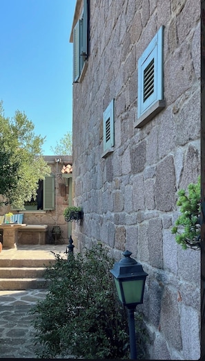 A stone building with shutters, a stone staircase, and a lantern. - Idasos Tasodalar (Ayvacik)