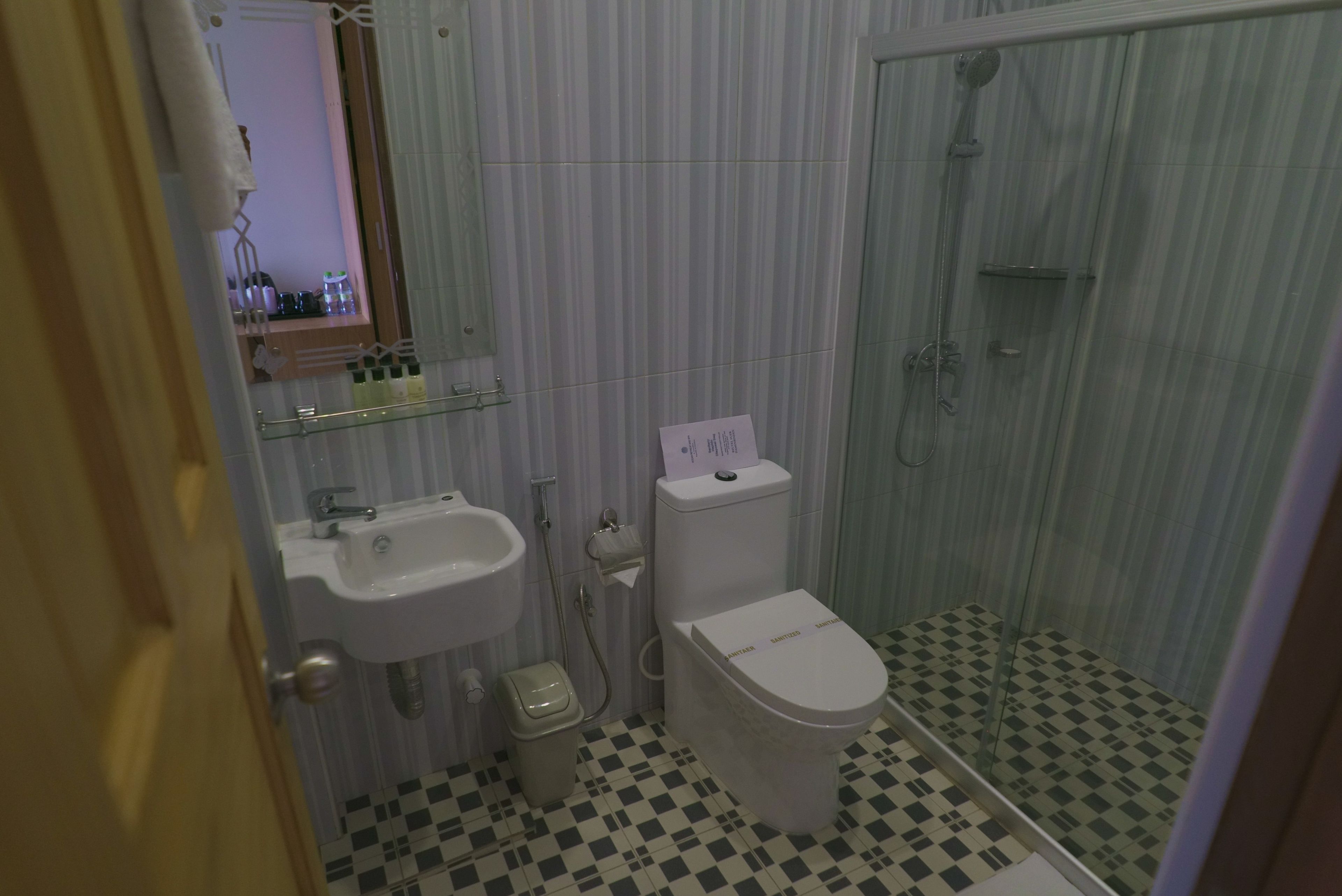 A bathroom with a sink, toilet, and shower.
