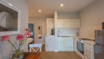A modern kitchen with wooden cabinets, a built-in oven, and a refrigerator.
