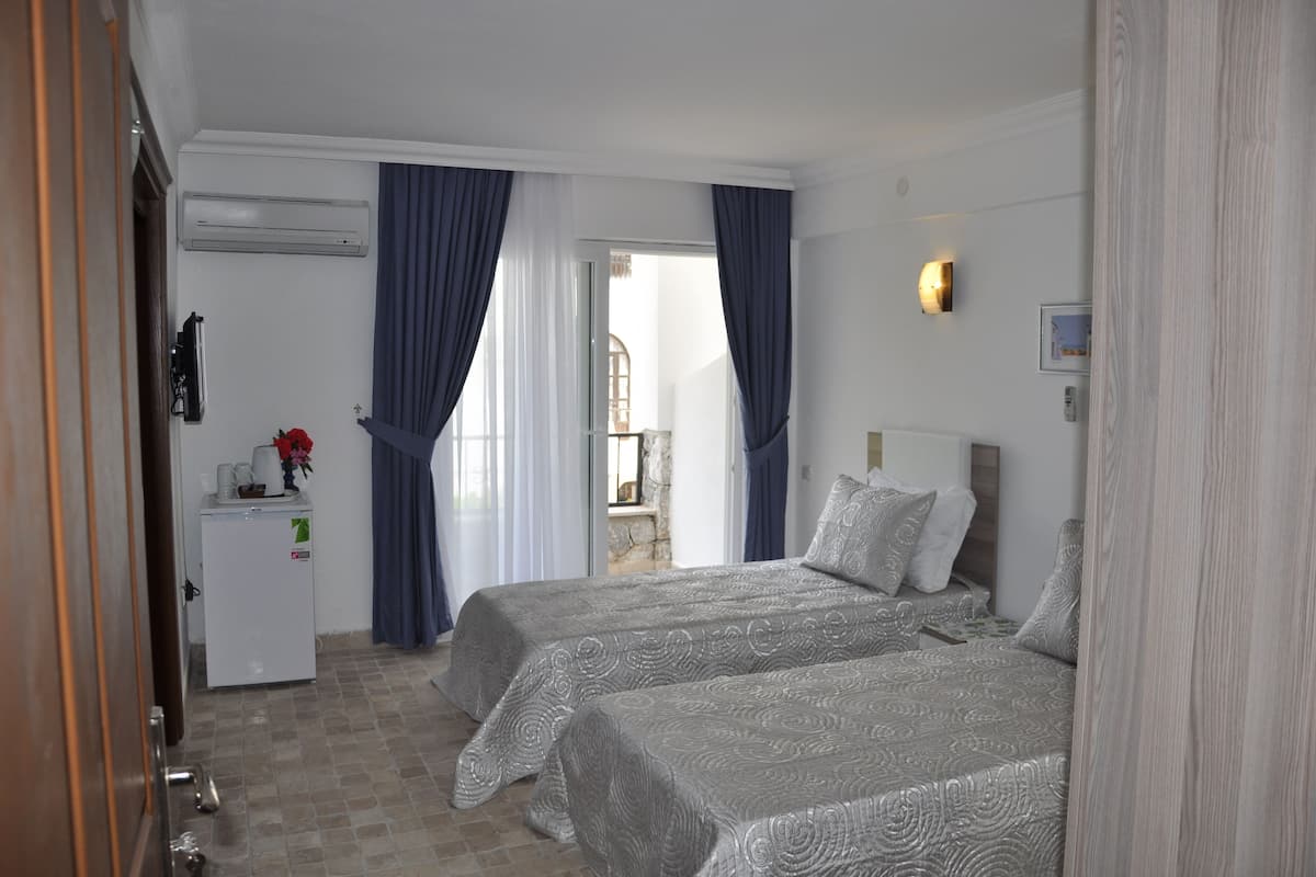Quadruple Room, Partial Sea View | Premium bedding, in-room safe, iron/ironing board, bed sheets