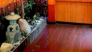 A room with wooden paneling, a large window, and a decorative tree with lights. - Yachuan Hotel (Taipei)