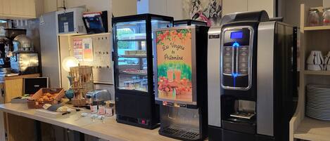 A self-service beverage station with a selection of drinks and a menu display.