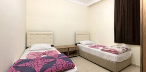 A small, clean room with two beds, a wooden nightstand, and a window with curtains. - Ali Unal Apart Otel (Alanya)