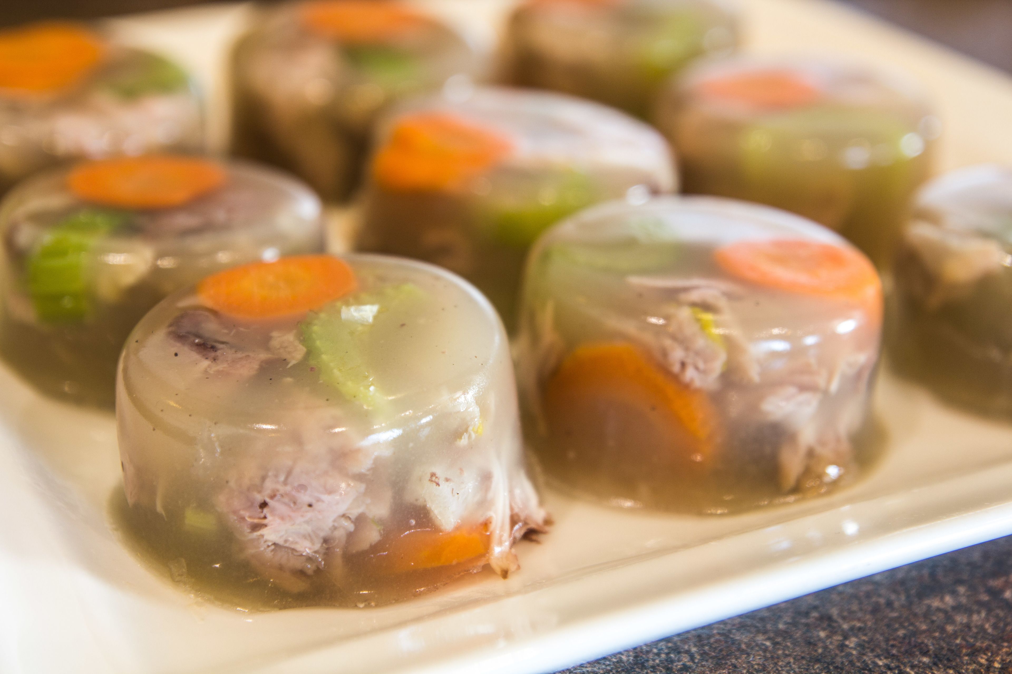 A plate of meatloaf with visible vegetables.