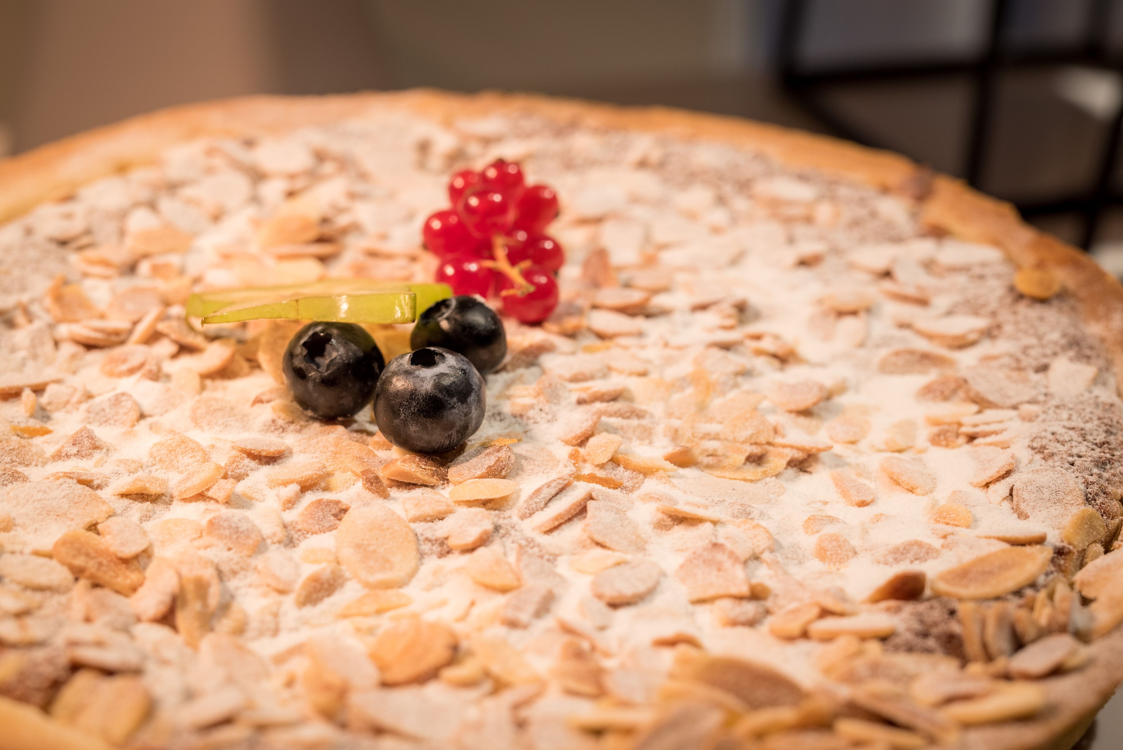 A pizza with toppings and garnishes.