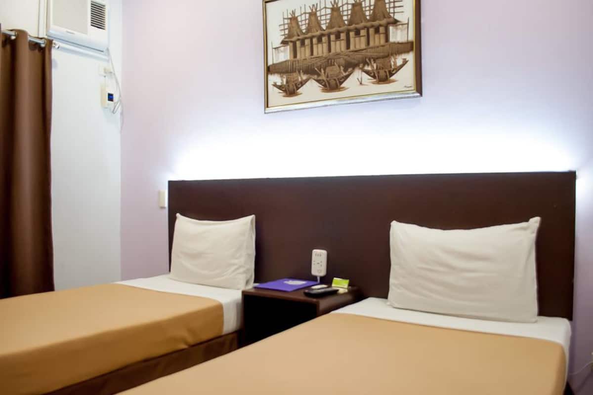 standard twin room | in-room safe, desk, laptop workspace, iron/ironing board