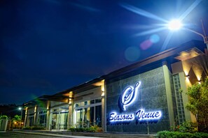A hotel exterior at night with a prominent illuminated sign reading "Seasons Venue." - Seasons Hotel and Convention Center (San Jose)
