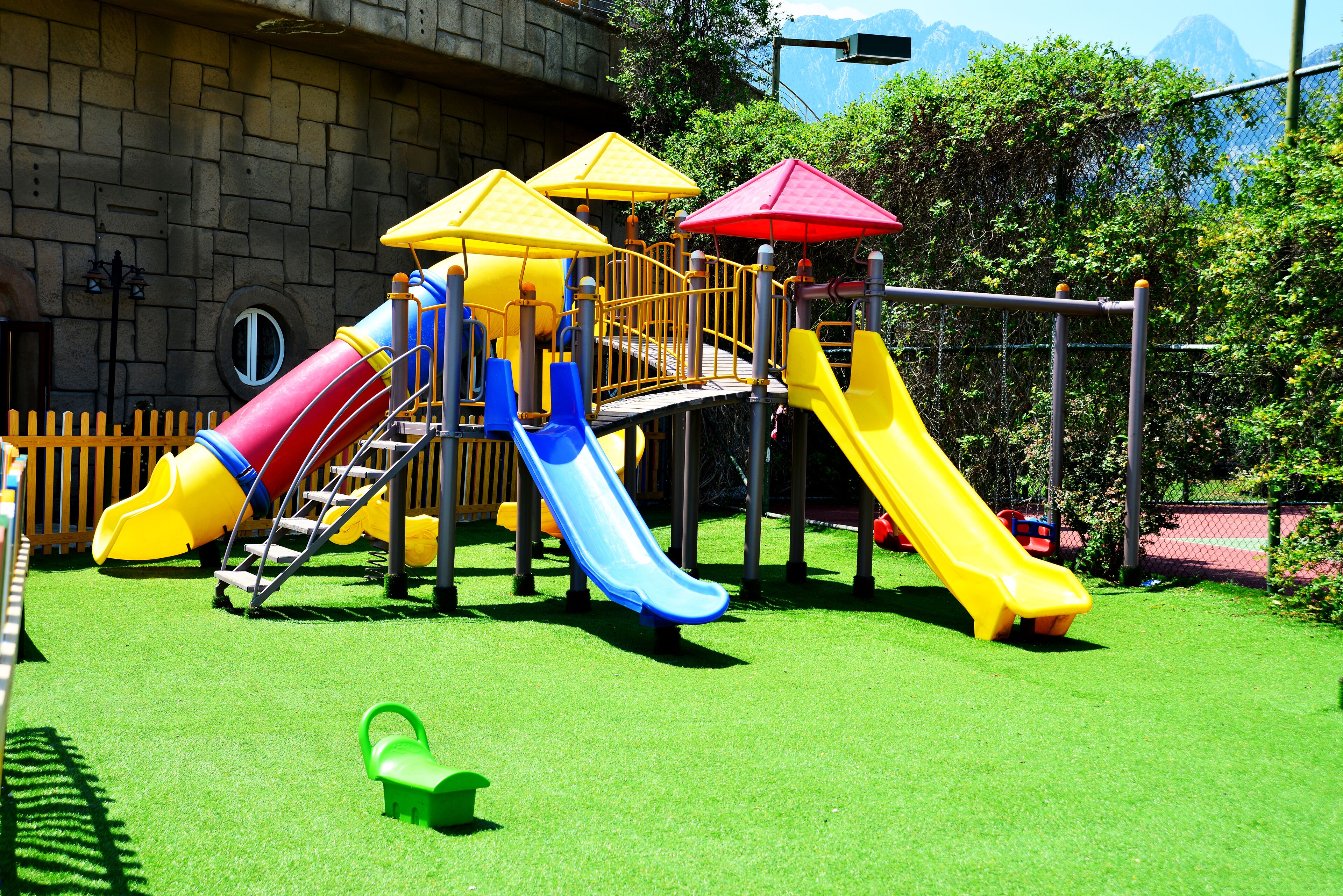 A playground with multiple slides and climbing structures.