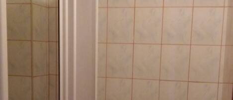 A bathroom with a toilet, sink, and shower.