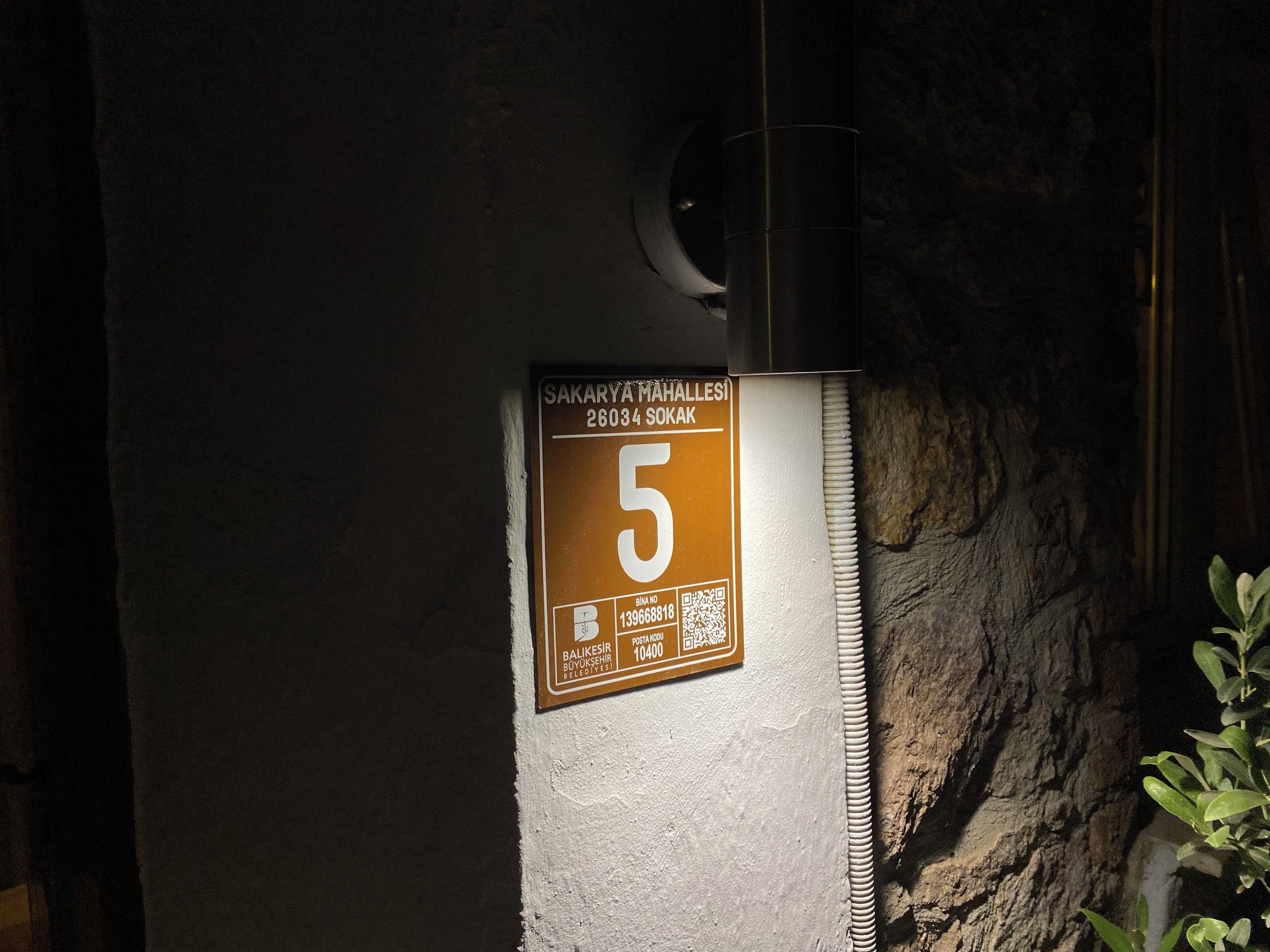 A sign with the number 5 on a wall, indicating room number or location.