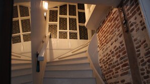 A staircase with white railings and a brick wall. - Macide Hanim Konagi (Ayvalik)
