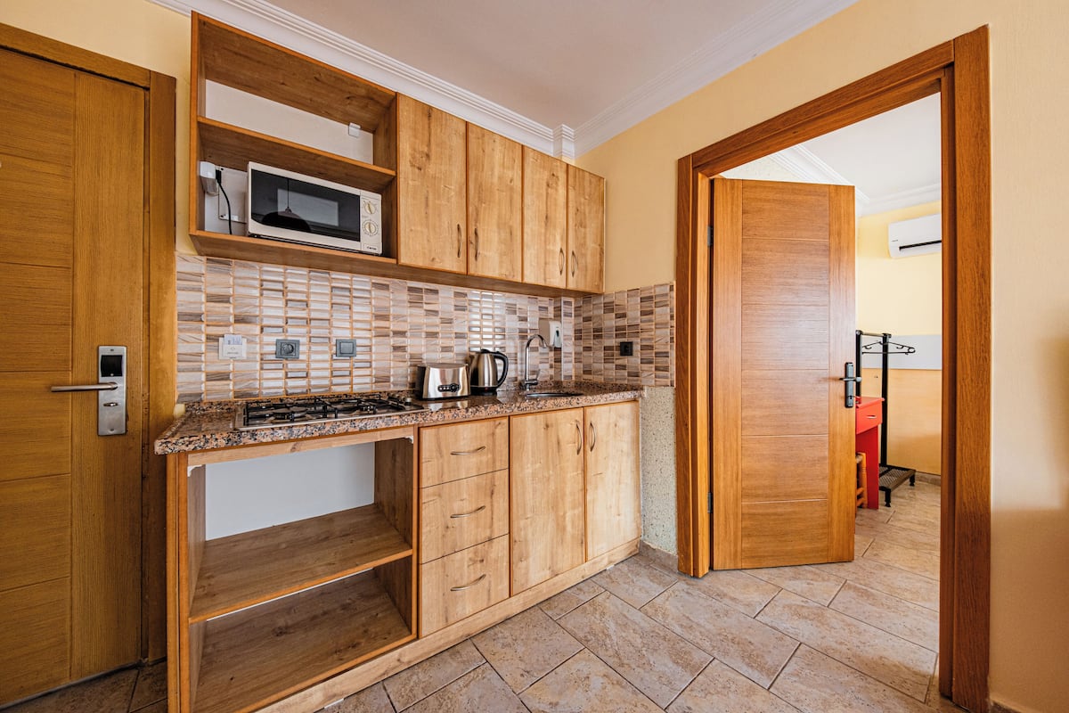 apartment, pool view | private kitchen | fridge, cleaning supplies