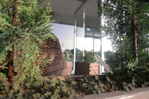 A modern building with a brick wall and glass windows.