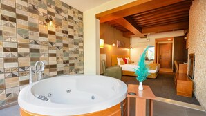 A modern bathroom with a large bathtub, a tiled wall, and a wooden ceiling. - Abant Aden Boutique Hotel & Spa (Bolu)