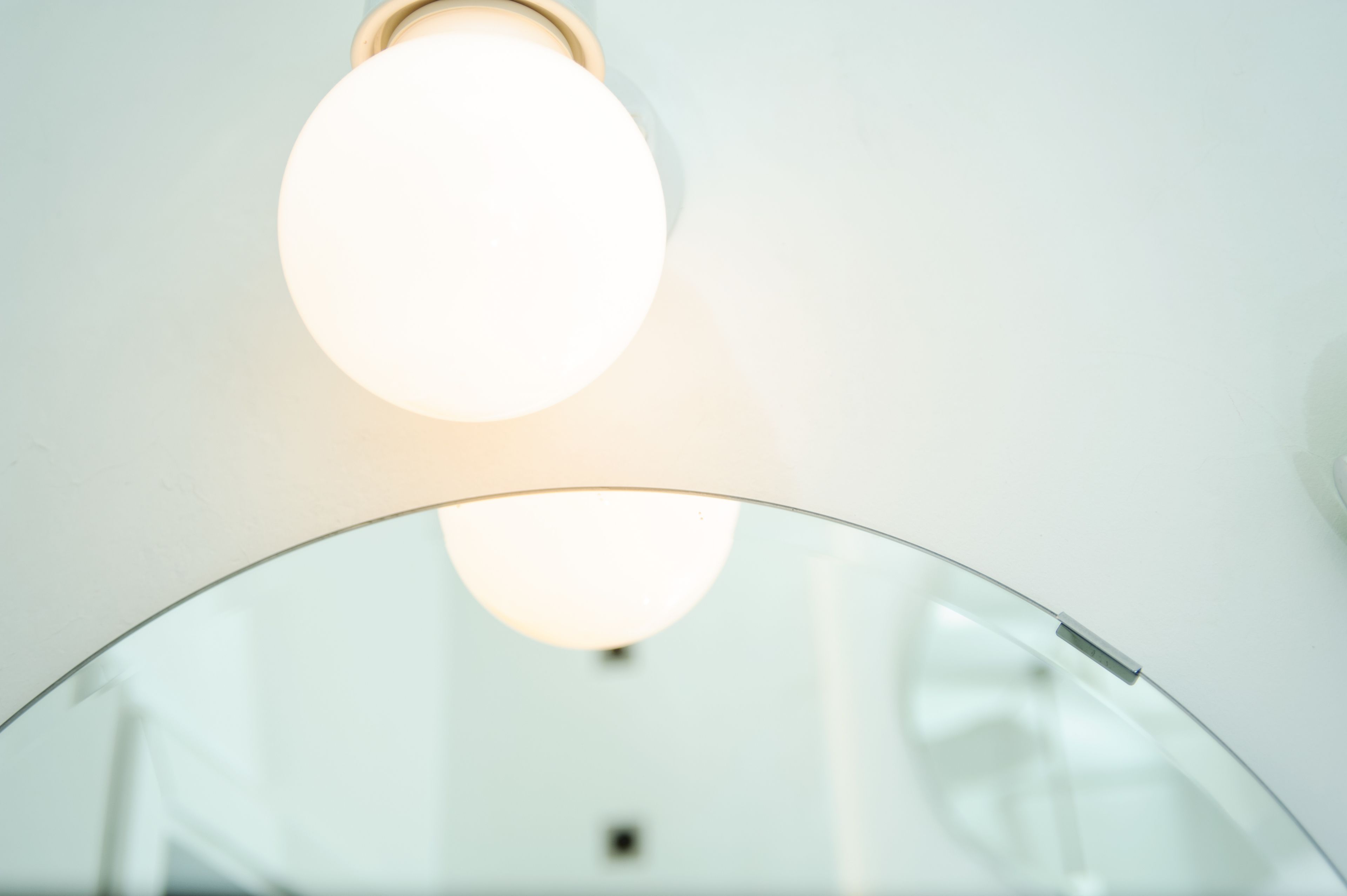 A circular mirror with a reflective surface.