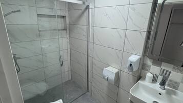 Standard Studio | Bathroom | Shower, hair dryer, slippers, towels