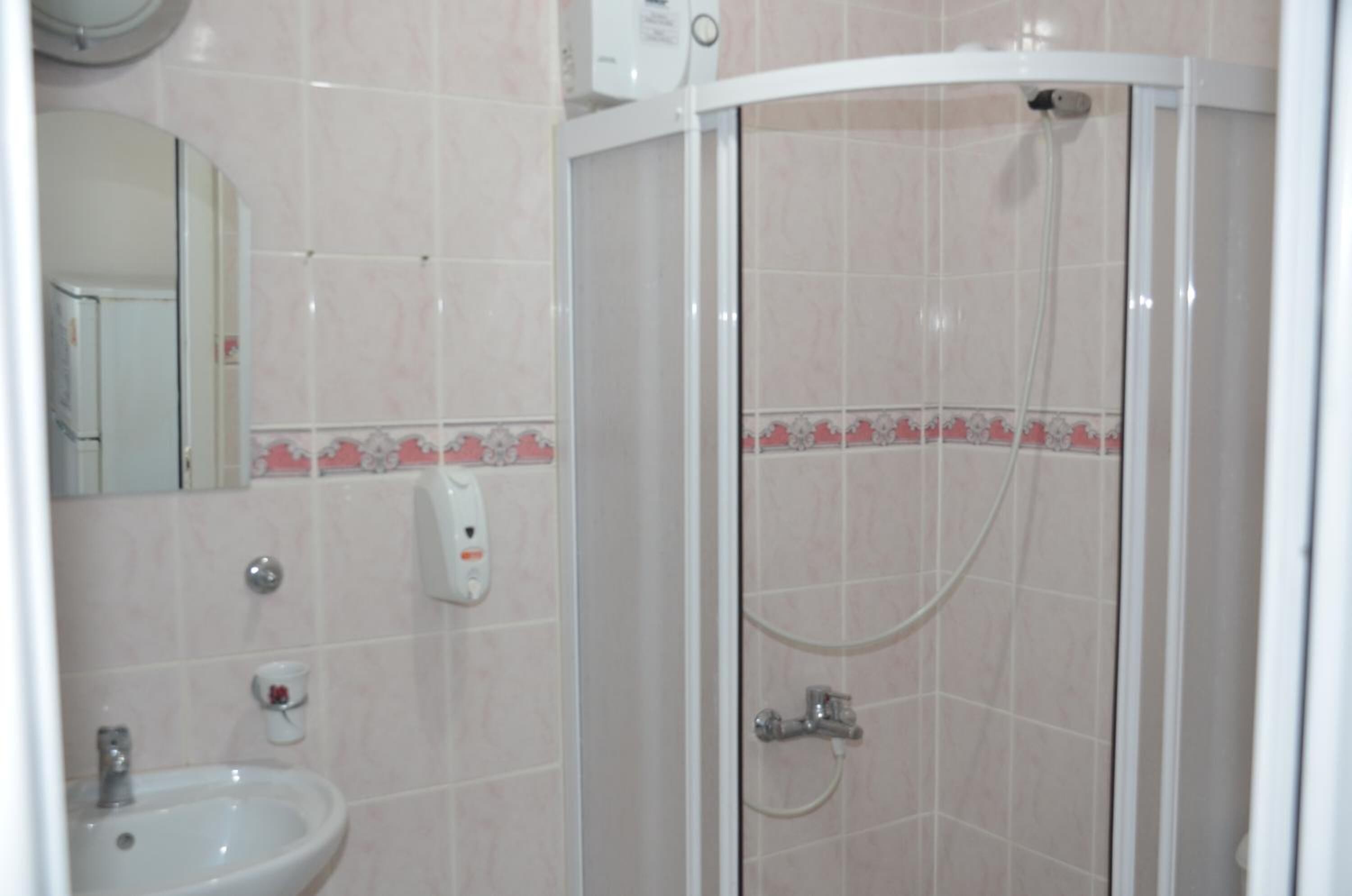 shower, hair dryer, slippers, towels