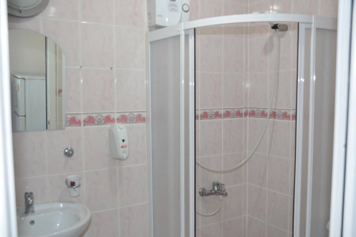 shower, hair dryer, slippers, towels