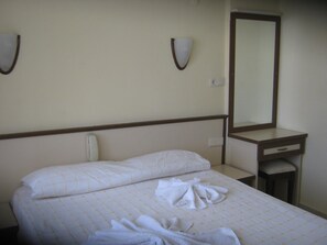 Desk, iron/ironing board, bed sheets