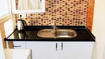 Fridge, stovetop, electric kettle, cookware/dishes/utensils