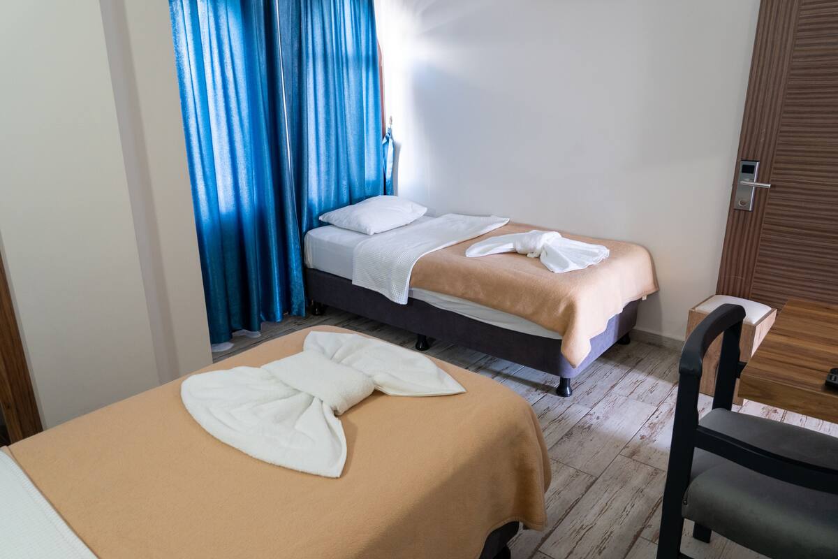 A hotel room with a bed, a chair, and a table.