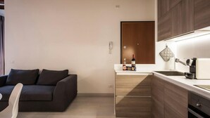 A modern kitchen with wooden cabinets, a countertop, and a built-in oven. - MYSWEETPLACE - Santa Maria Formosa Apartment (Venice)