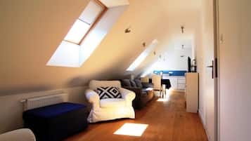 Apartment, 1 Bedroom (Bianco) | Living area | Flat-screen TV, toys