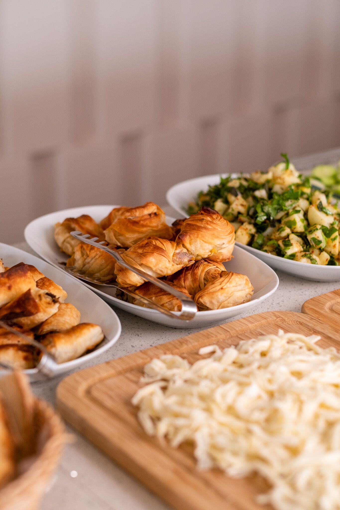A table with food items including pastries and a salad.