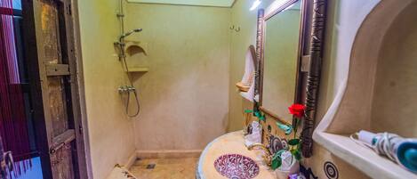 A bathroom with a bathtub, a sink, and a shower.