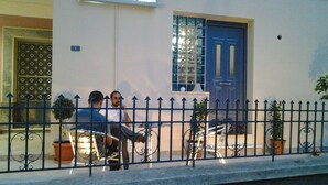 A building with a blue door and a sign that reads "MASTIC". - Mastic Point Studios (Chios)