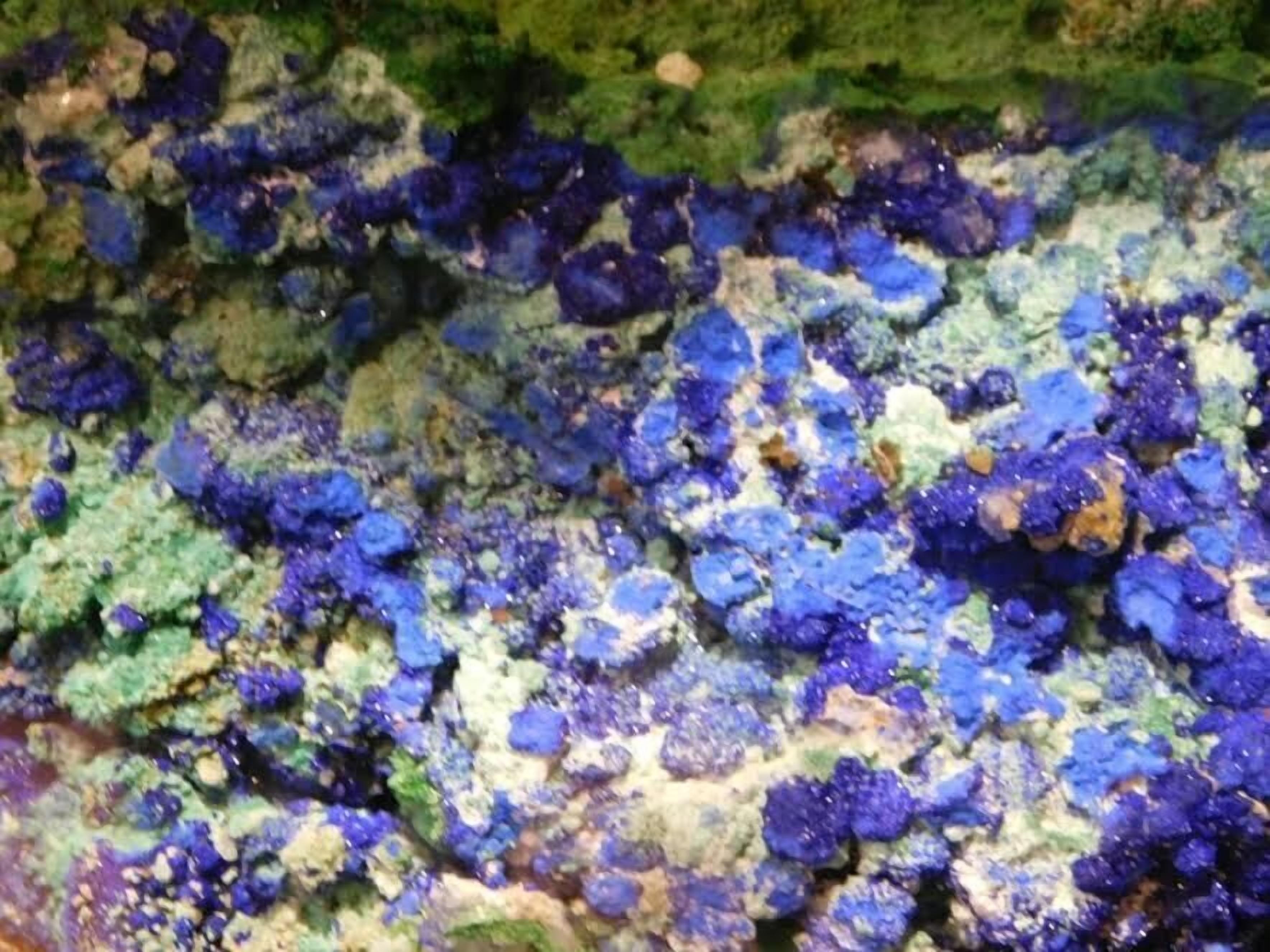 A close-up of a textured surface with a pattern of blue and green colors.