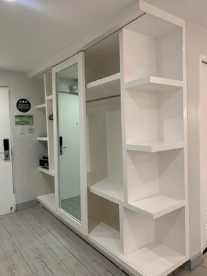 A room with a sliding glass door closet, white walls, and a tiled floor. - LeBlanc Hotel and Resort (Antipolo)