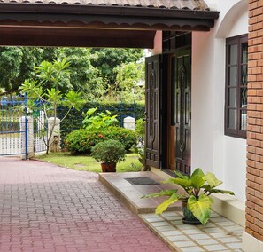 A covered entrance with a tiled pathway leading to a door with a decorative metal gate. - A Taste of Europe in Chiang Mai (Chiang Mai)