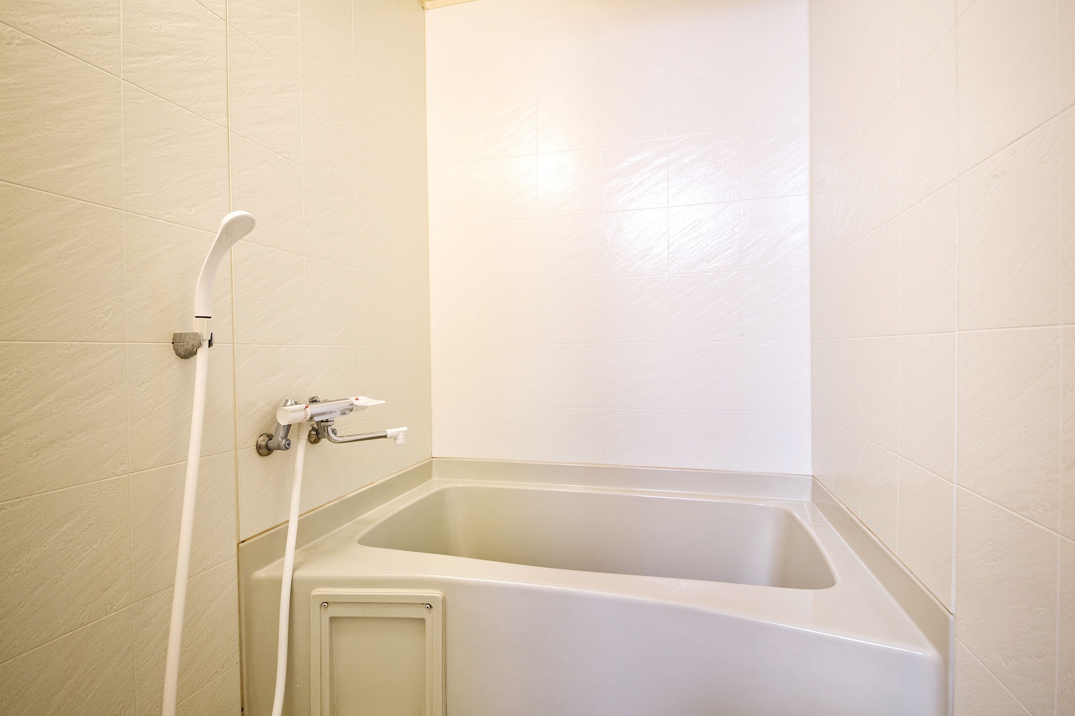 A bathroom with a bathtub and a shower.