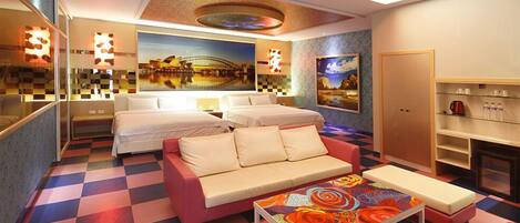 A hotel room with a checkered floor, a sofa bed, a colorful table, and a painting on the wall.