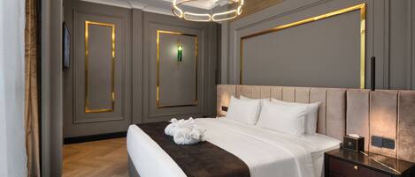 A modern hotel room with a large bed, a bedside table, and a unique geometric light fixture.