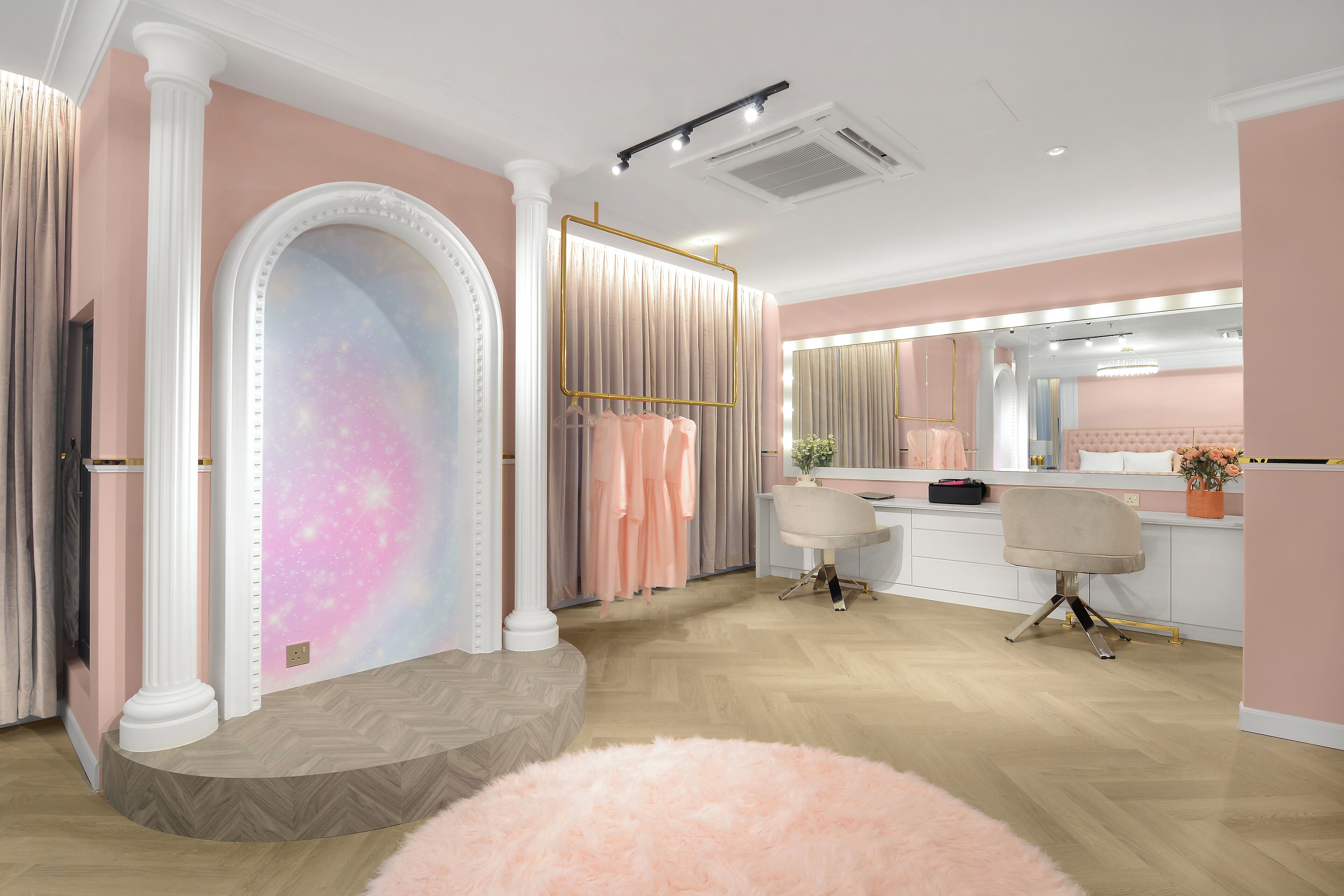 Quarto com toucador, espelho e duas cadeiras.