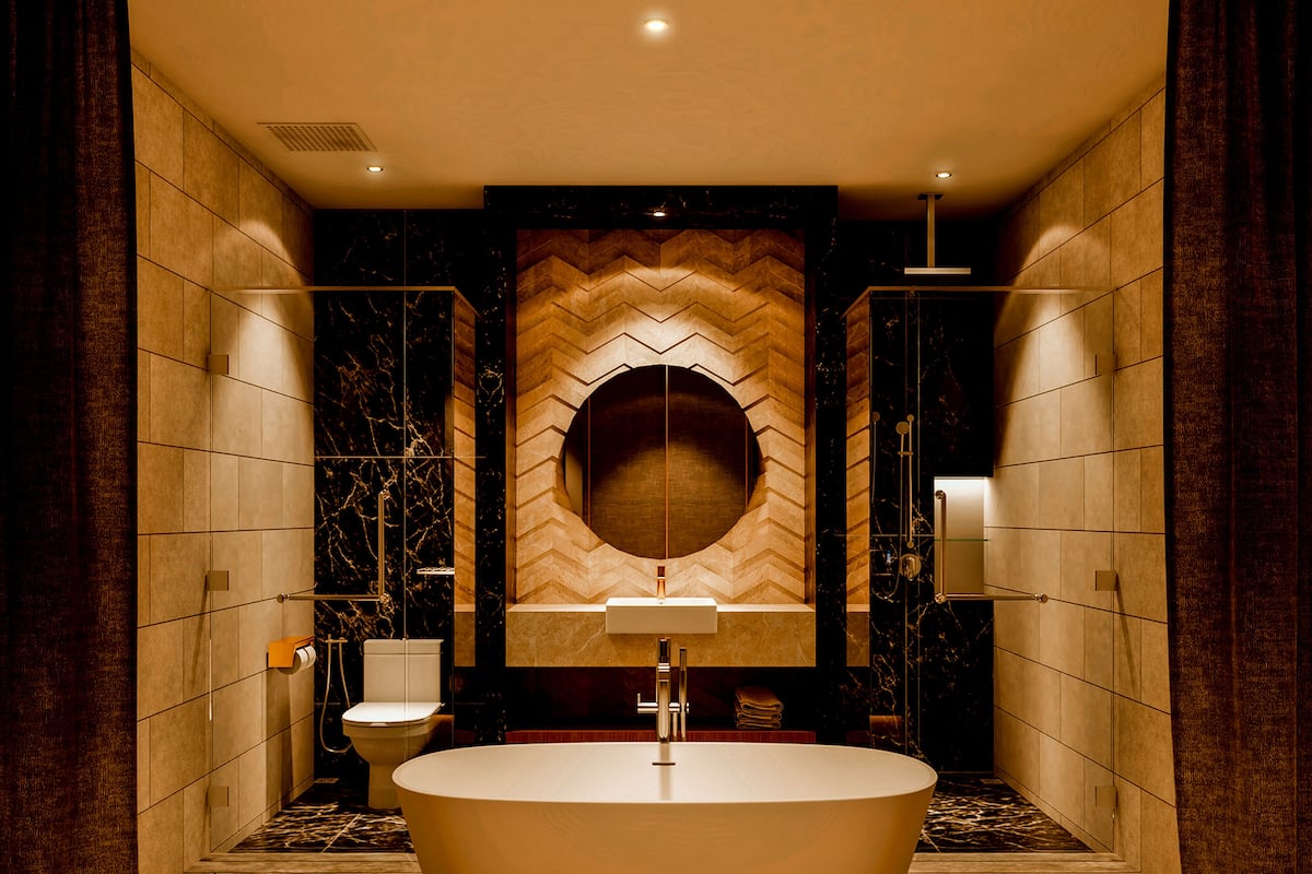 A modern bathroom with a freestanding bathtub, a toilet, and a large mirror above the sink.