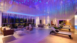 A rooftop lounge with seating and a pool. - The Granite Luxury Hotel Penang (George Town)
