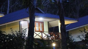 A two-story building with a balcony, surrounded by trees. - Mookies Bungalow (Ko Mook)