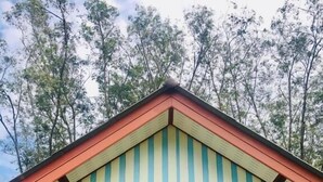 A small, single-story building with a sloped roof and a porch. - Mookies Bungalow (Ko Mook)