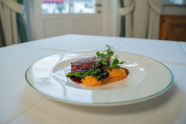 A plate of food on a white table.