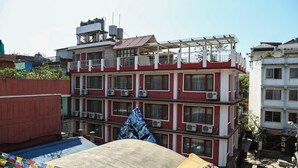 A multi-story building with balconies and air conditioning units. - Hotel Outfitter Nepal (Kathmandu)