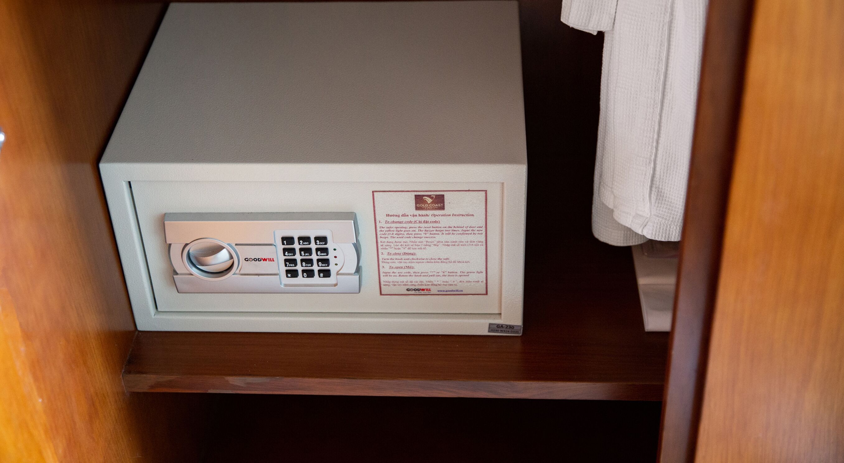 A safe with a keypad and a manual operation instruction label.
