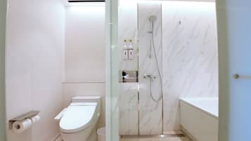 A bathroom with a toilet, a shower, and a bathtub.
