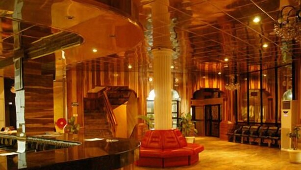A lobby with a reception desk, a staircase, and a seating area. - Sharon Ultimate Hotels (Abuja)