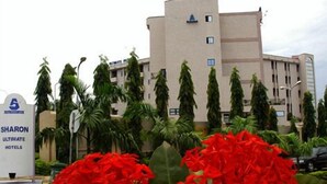 A hotel building with a sign for 'Sharon Ultimate Hotels'. - Sharon Ultimate Hotels (Abuja)