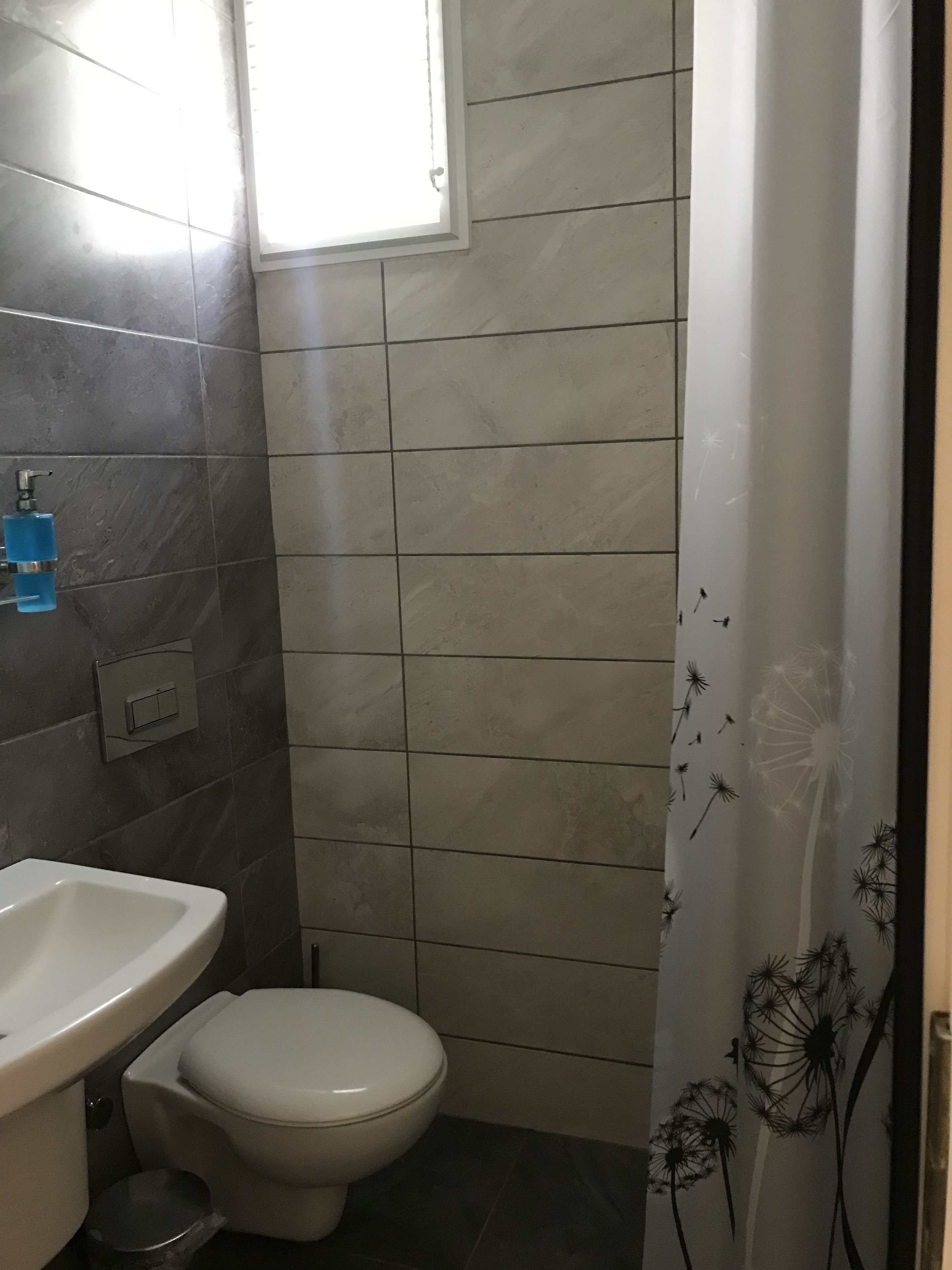 economy double room | bathroom | shower, free toiletries, hair dryer, slippers
